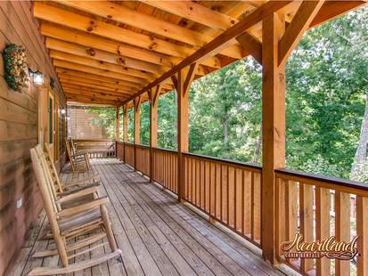 Front porch with wooden rocking chairs and swing